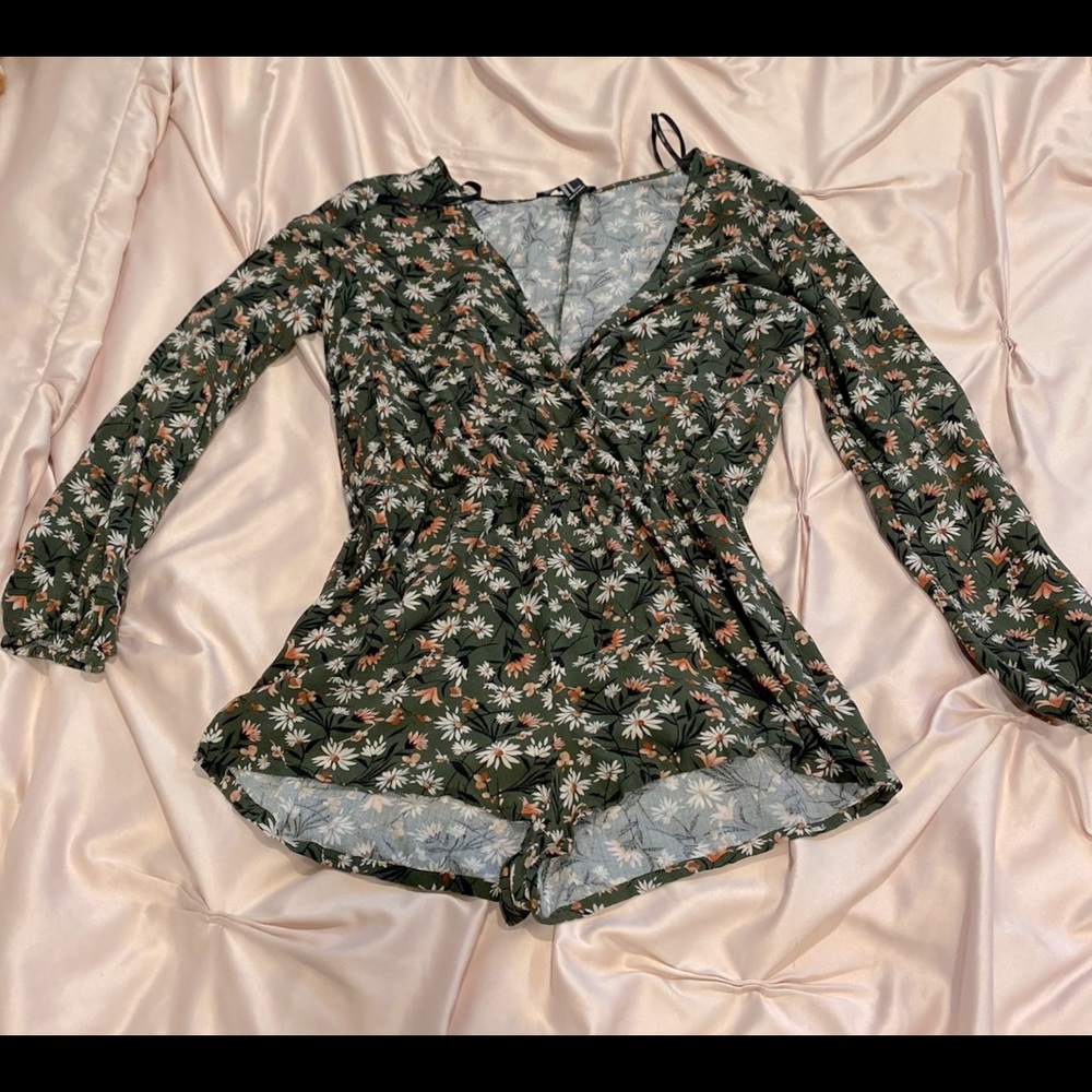 Long sleeved floral patterned romper.